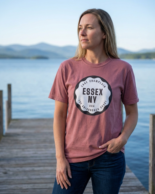 Woman wearing a t-shirt with 'Essex NY' design by a lake