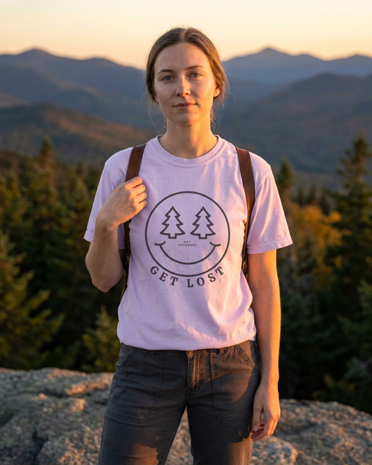 Person wearing a 'Get Lost' t-shirt with mountains in the background