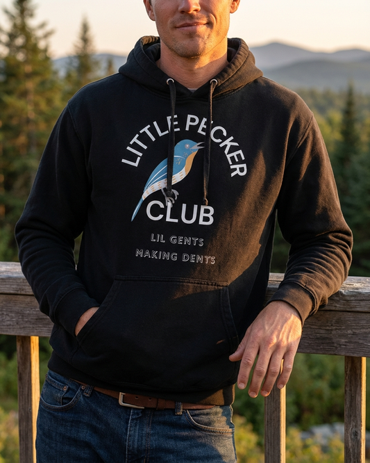 Person wearing a hoodie with 'Little Pecker Club' logo outdoors