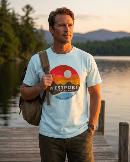 Man wearing a 'Westport' t-shirt on a dock with a scenic background